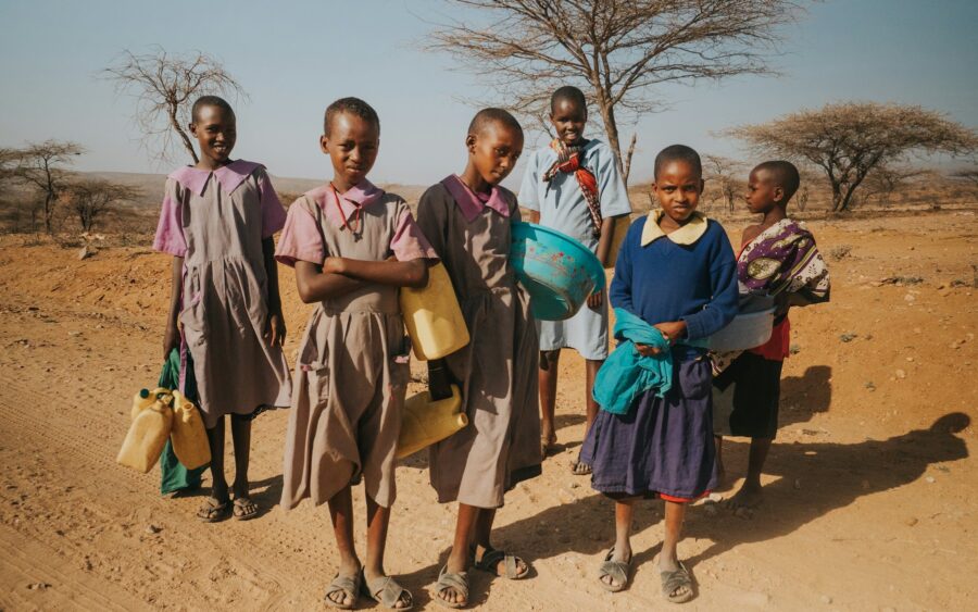 Children standing in a dry landscape