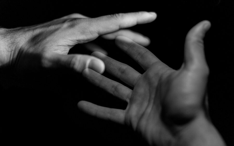 Two hands reaching toward each other
