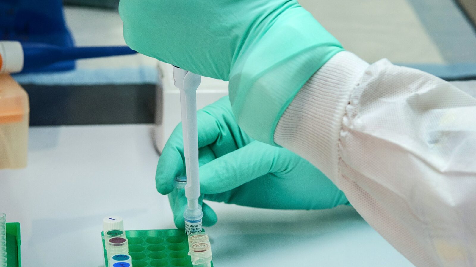 A researcher using a pipette in a microbiology lab