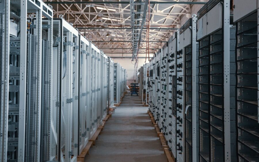A server room aisle lined with equipment racks