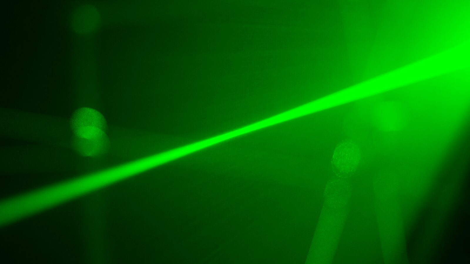 A green laser beam in the dark