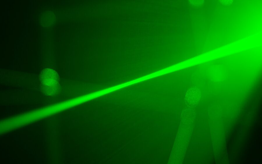 A green laser beam in the dark