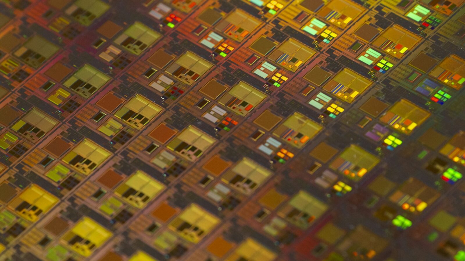 A close up of a chip surface patterned with small squares