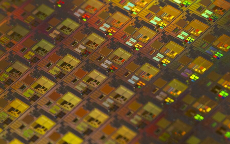 A close up of a chip surface patterned with small squares