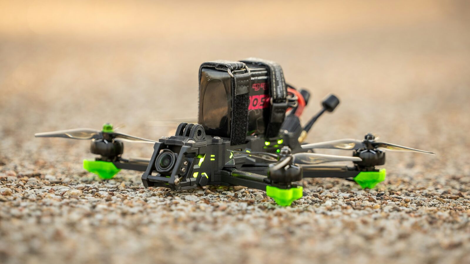A small racing drone resting on the ground
