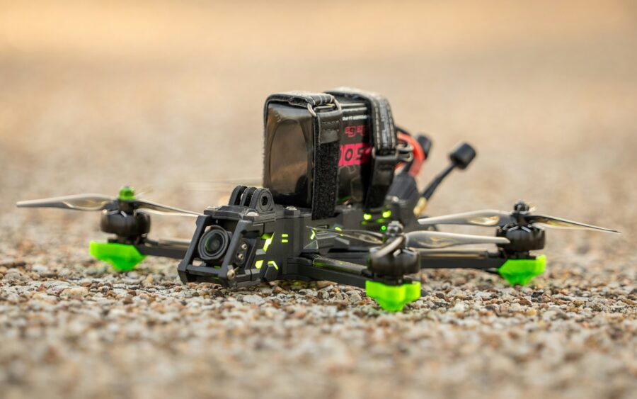 A small racing drone resting on the ground