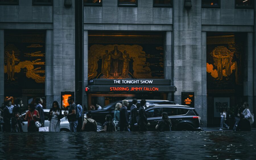 People and cars in a flooded city street