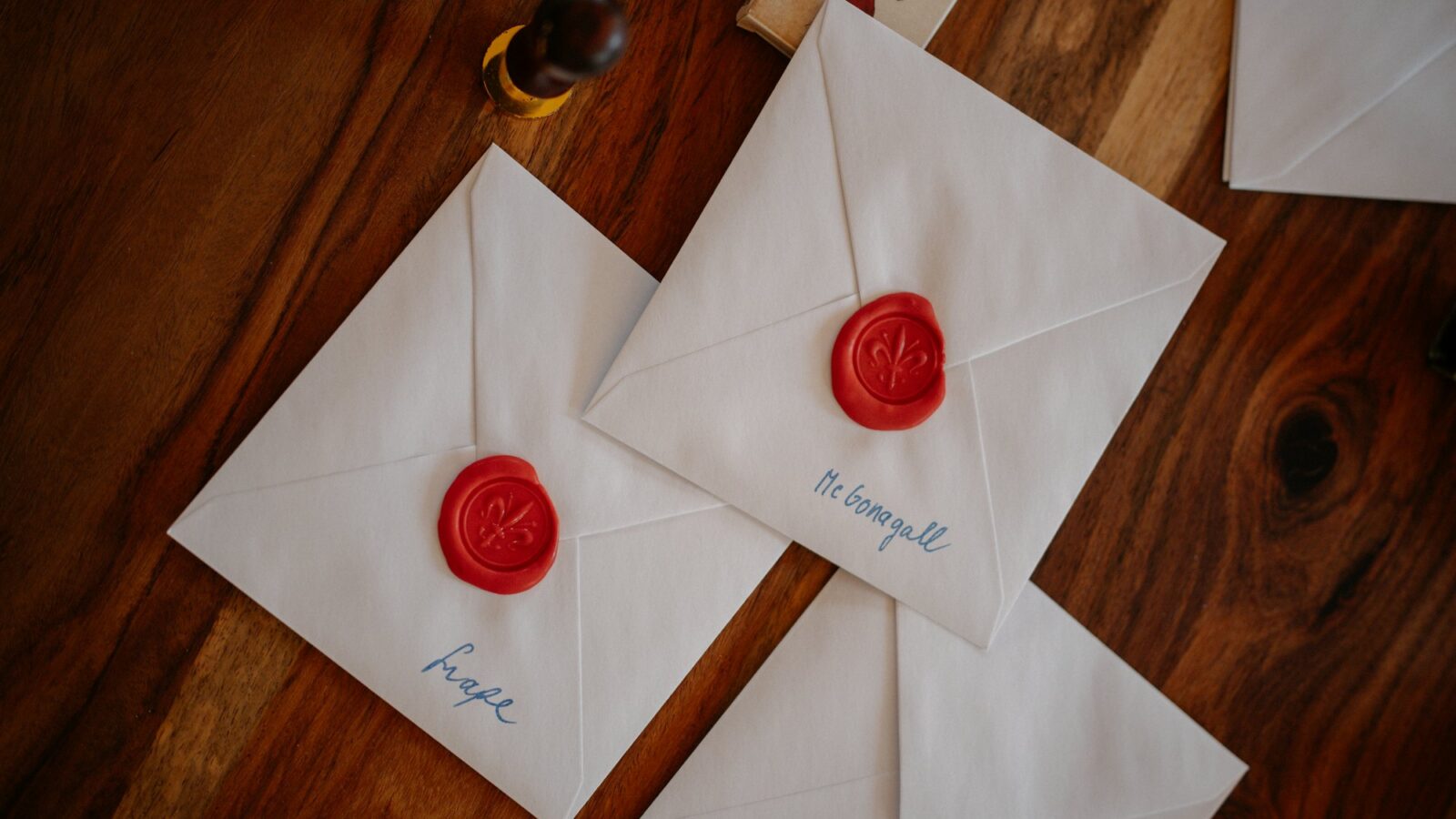 Envelopes sealed with red wax on a wooden table