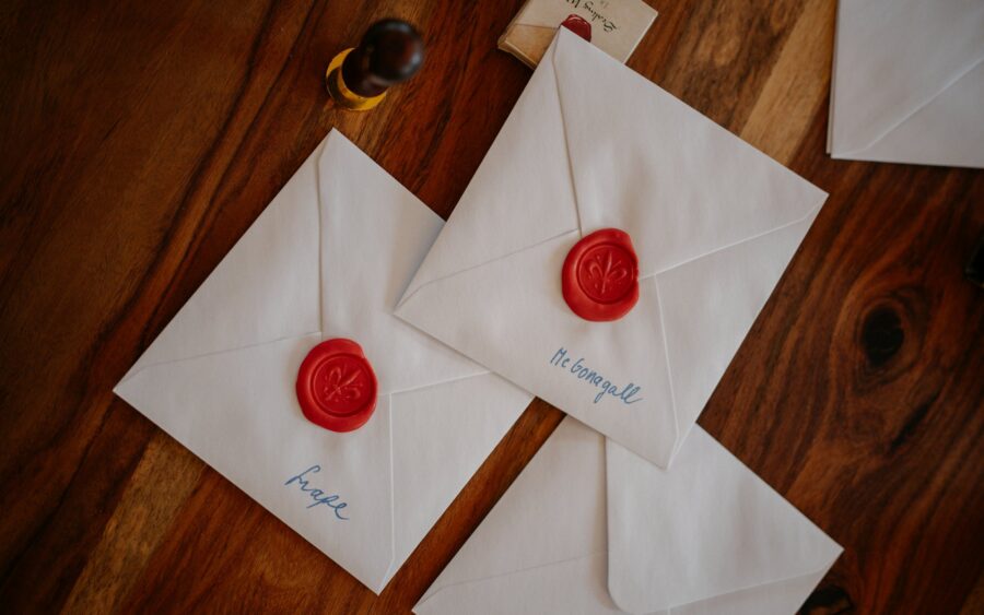 Envelopes sealed with red wax on a wooden table