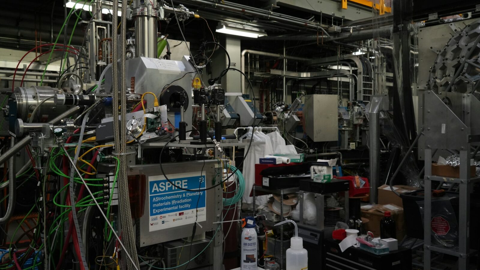 A physics laboratory crowded with pipes, wires and equipment