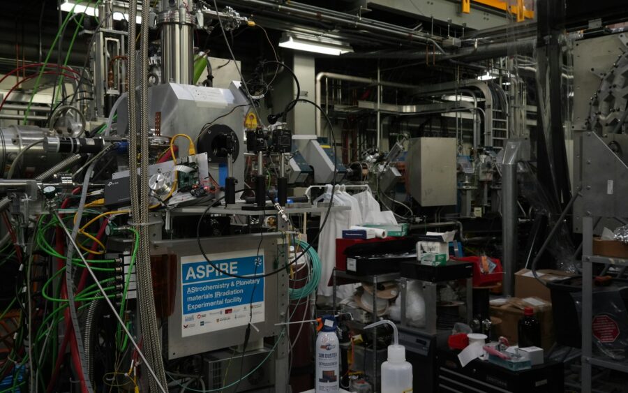 A physics laboratory crowded with pipes, wires and equipment