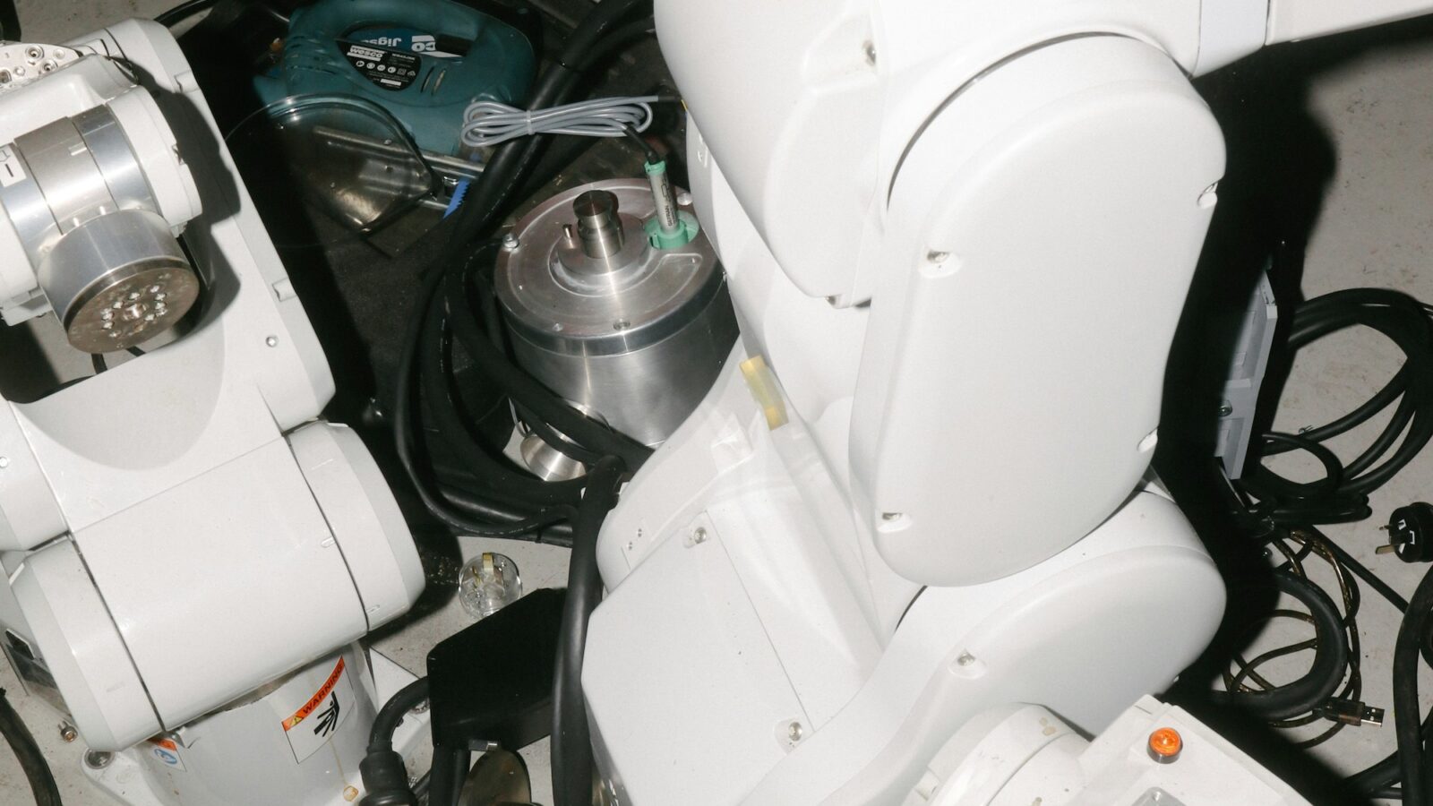 White robotic arms in a workshop