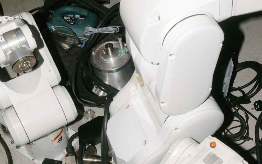 White robotic arms in a workshop